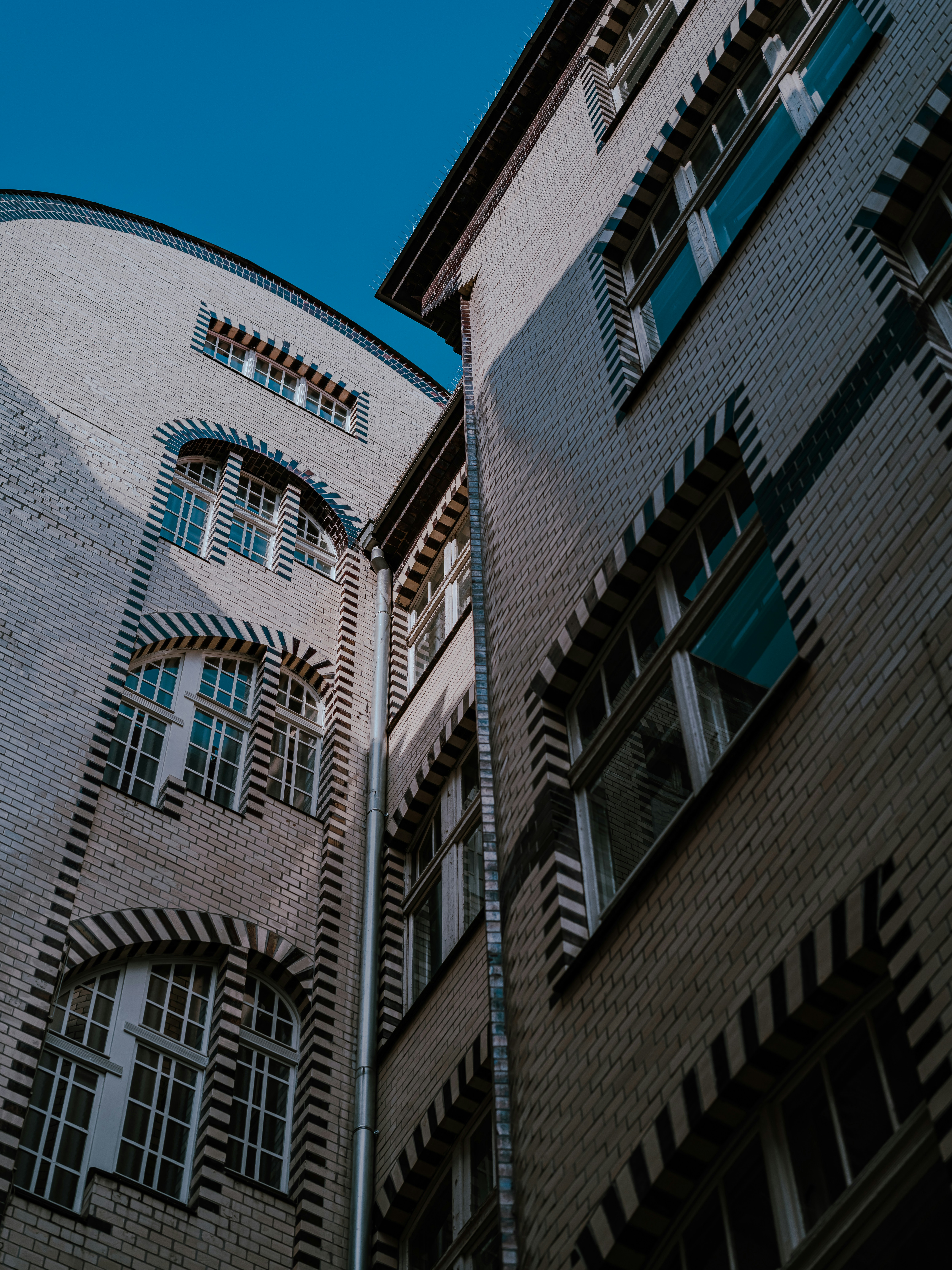 a tall building with lots of windows next to another building