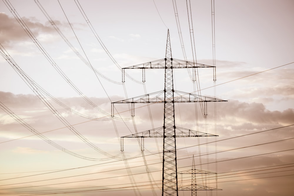 a tall tower with lots of power lines above it