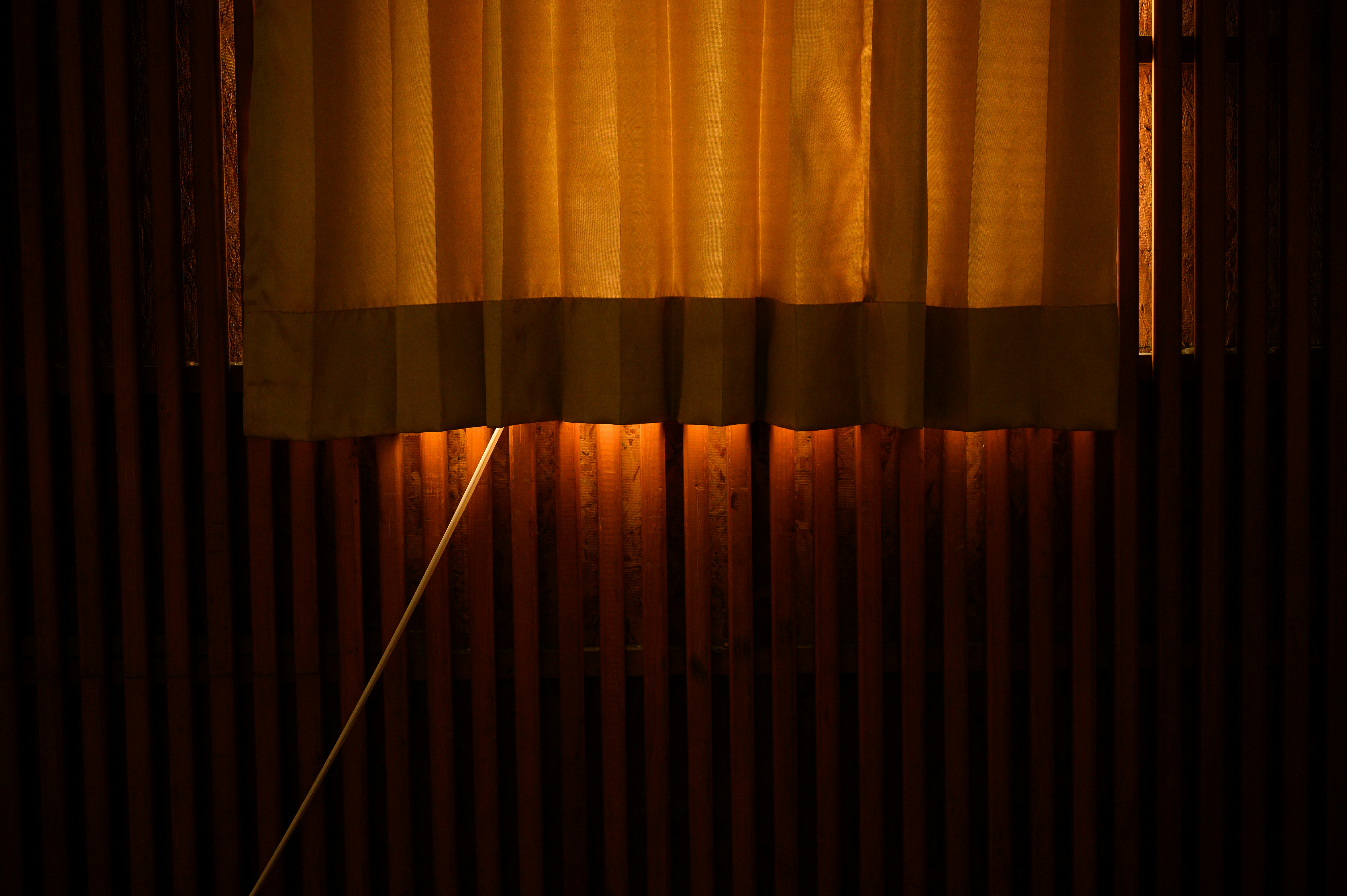 a light shining through a window in a dark room