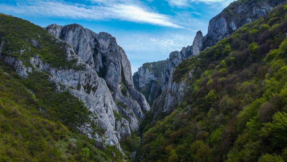 a view of a mountain with a river running between it