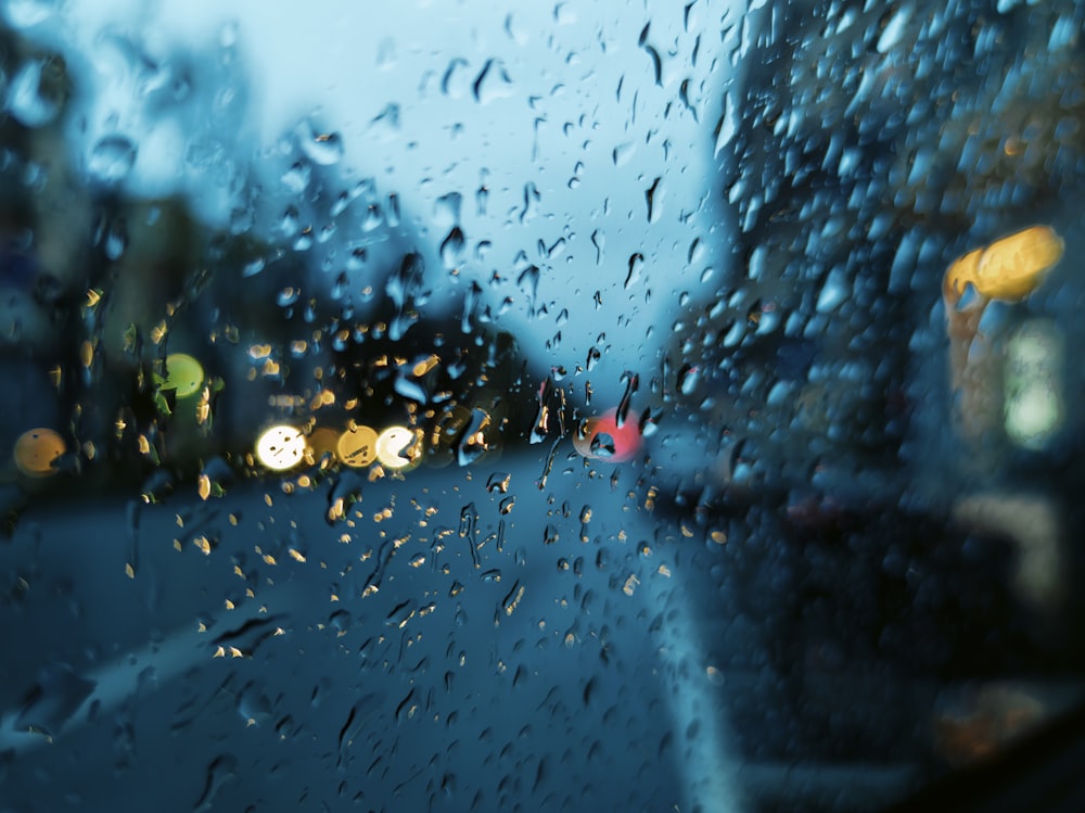 a view of a street through a rain covered window