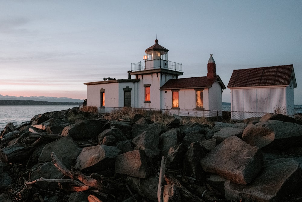 a light house sitting on top of a rocky shore