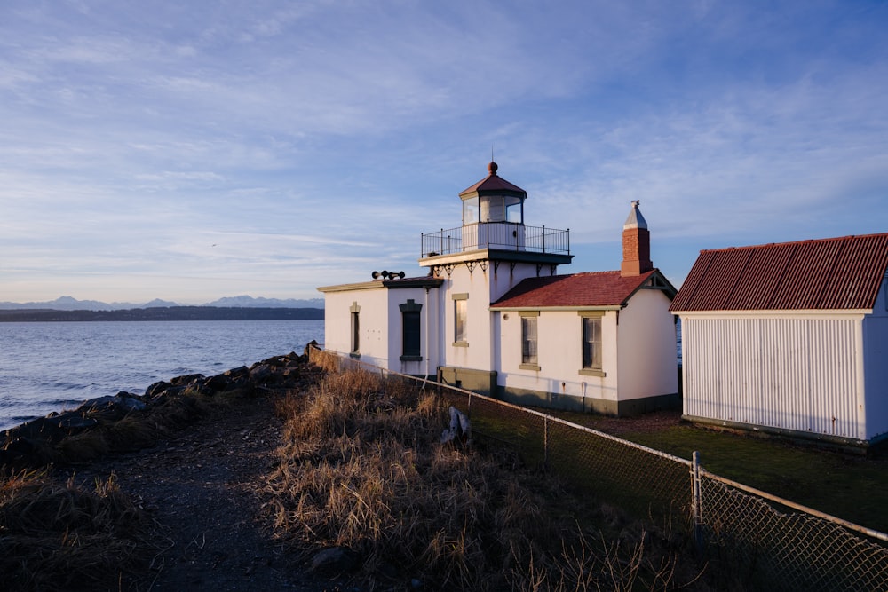 a lighthouse on the shore of a body of water