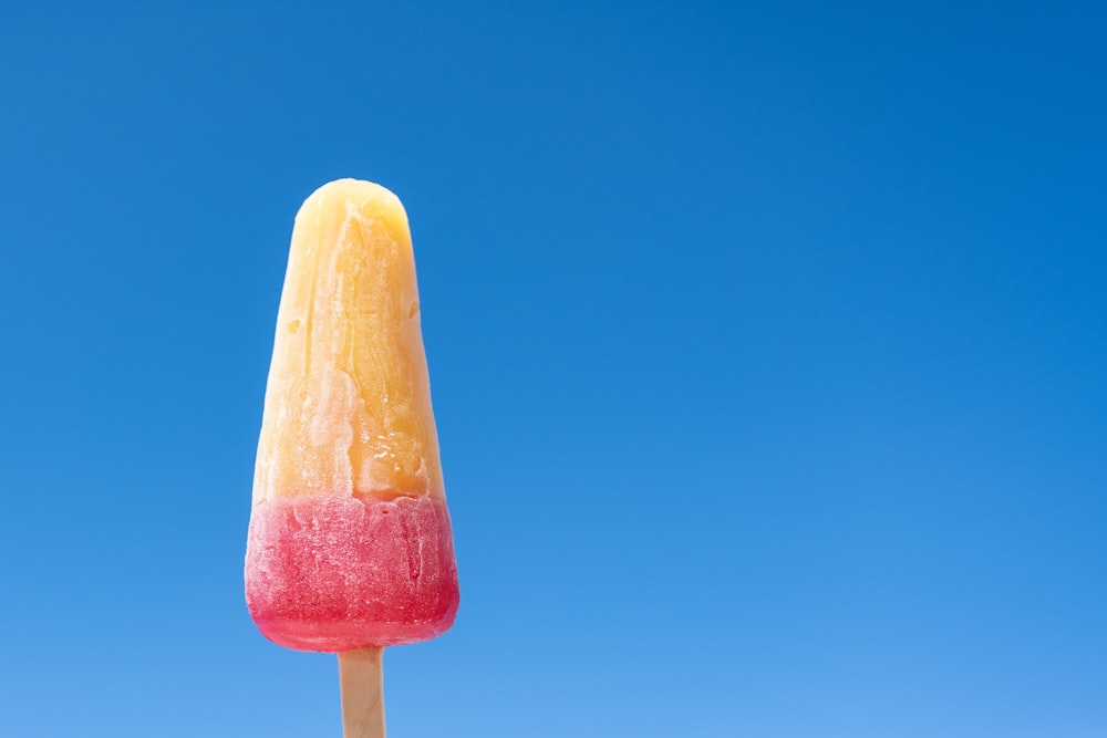 a colorful popsicle with a blue sky in the background