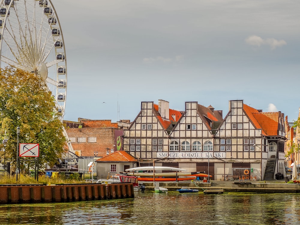 a large ferris wheel sitting next to a river