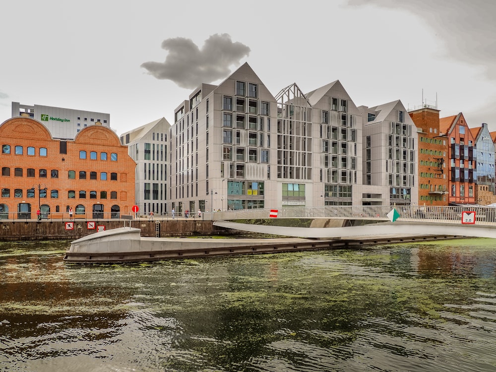 a body of water with buildings in the background