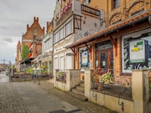 a row of buildings on a cobblestone street