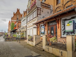 a row of buildings on a cobblestone street