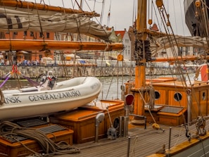 A group of happy students practicing docking maneuvers in a busy Giżycko marina