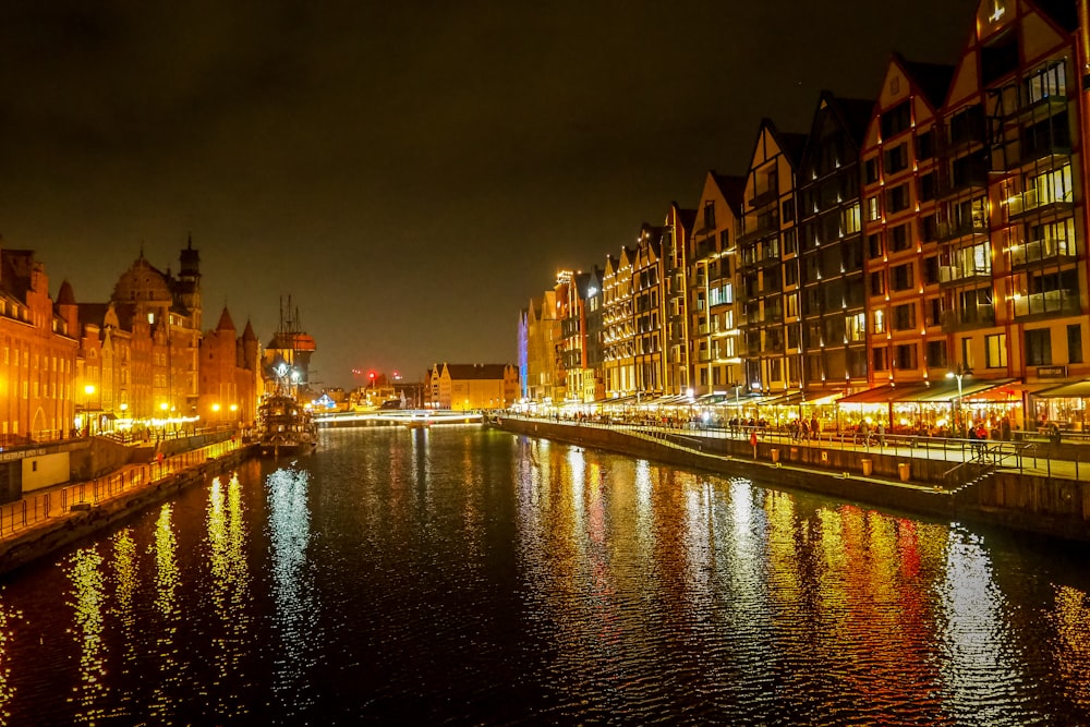 a river running through a city next to tall buildings