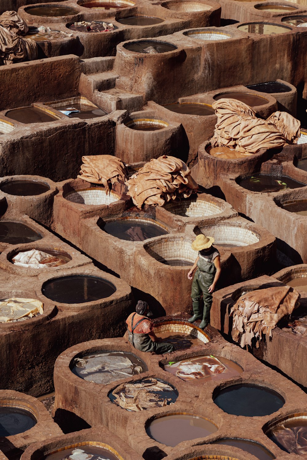 a man standing in front of a large number of pots