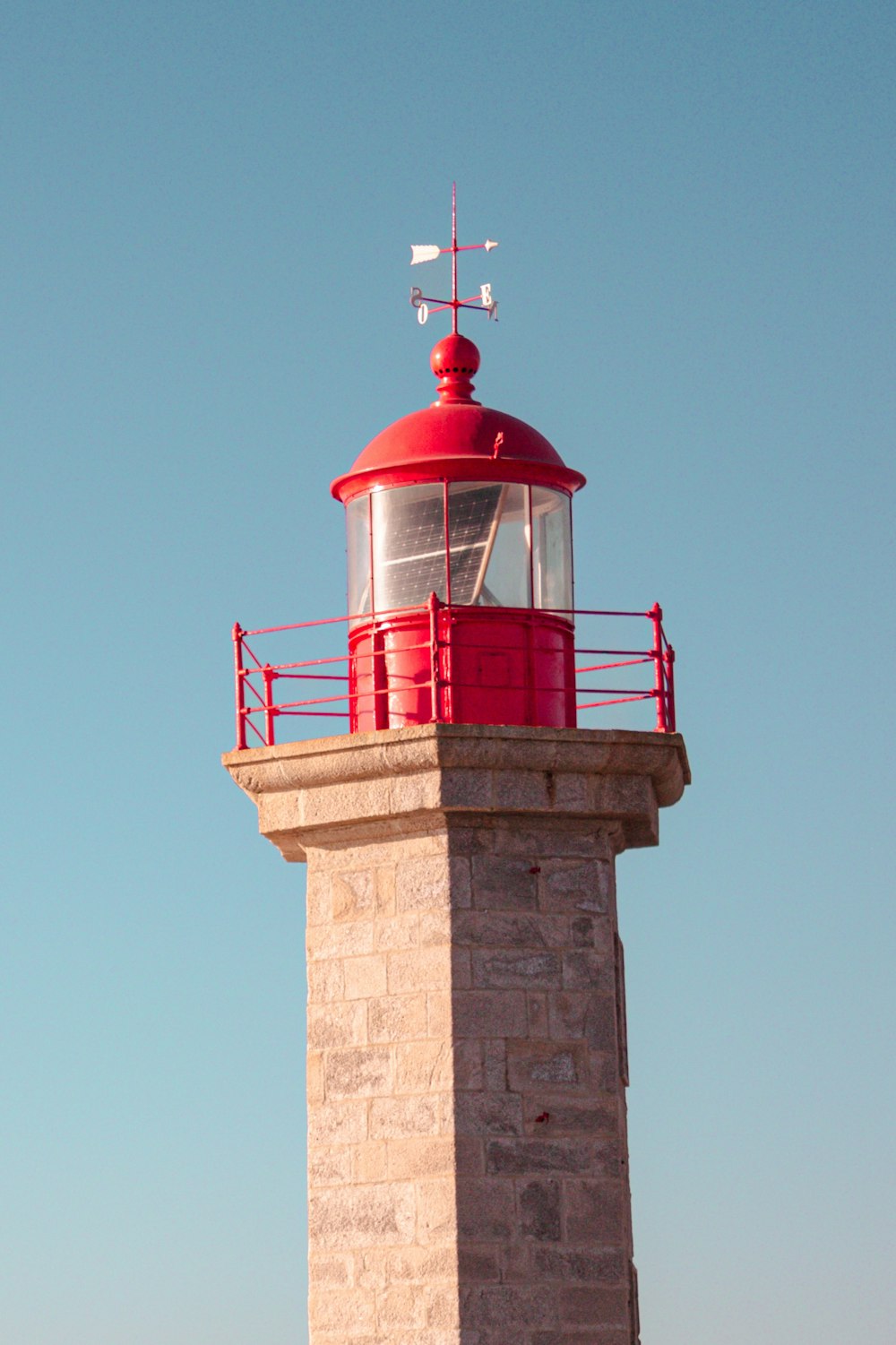 a red and white lighthouse on a clear day