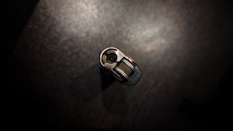 Hands holding a key and lock mechanism during repair.