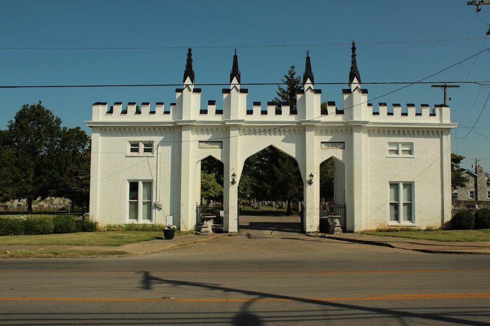 a large white building with a gate on the side of it