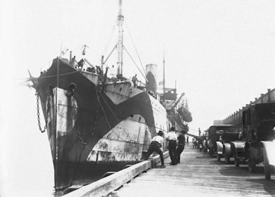 Pink and black toned 24m landing craft tank vessel docked at port.
