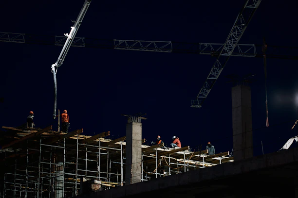 Construction team working on a modern building site during daylight.