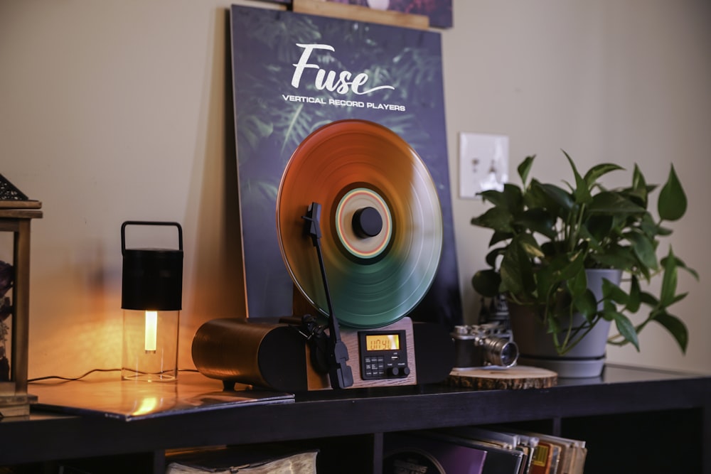 a record player sitting on top of a book shelf