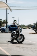 A shiny new motorcycle parked outside a Florida Motos dealership under a clear sky.