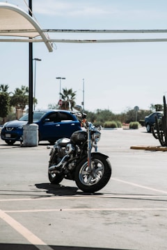 A shiny new motorcycle parked outside a Florida Motos dealership under a clear sky.