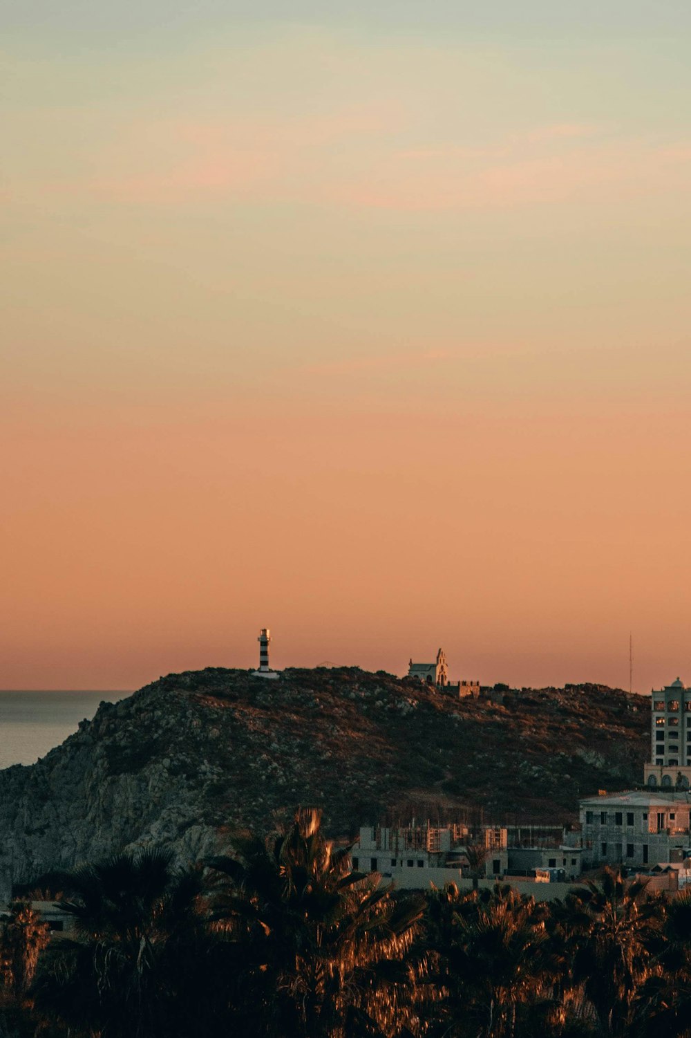 a view of a city with a lighthouse on top of it