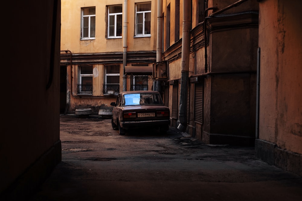a car parked in an alley between two buildings