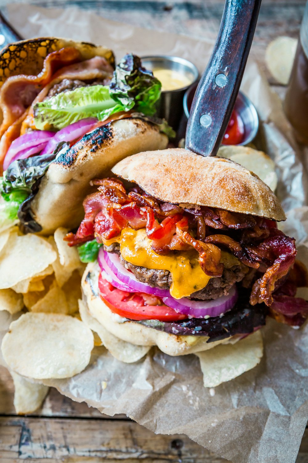 a sandwich with bacon, lettuce, tomato, and other toppings