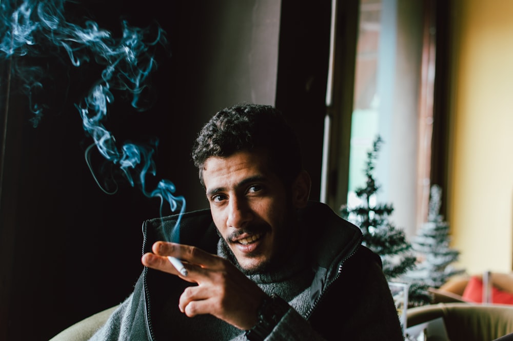 a man smoking a cigarette in a living room