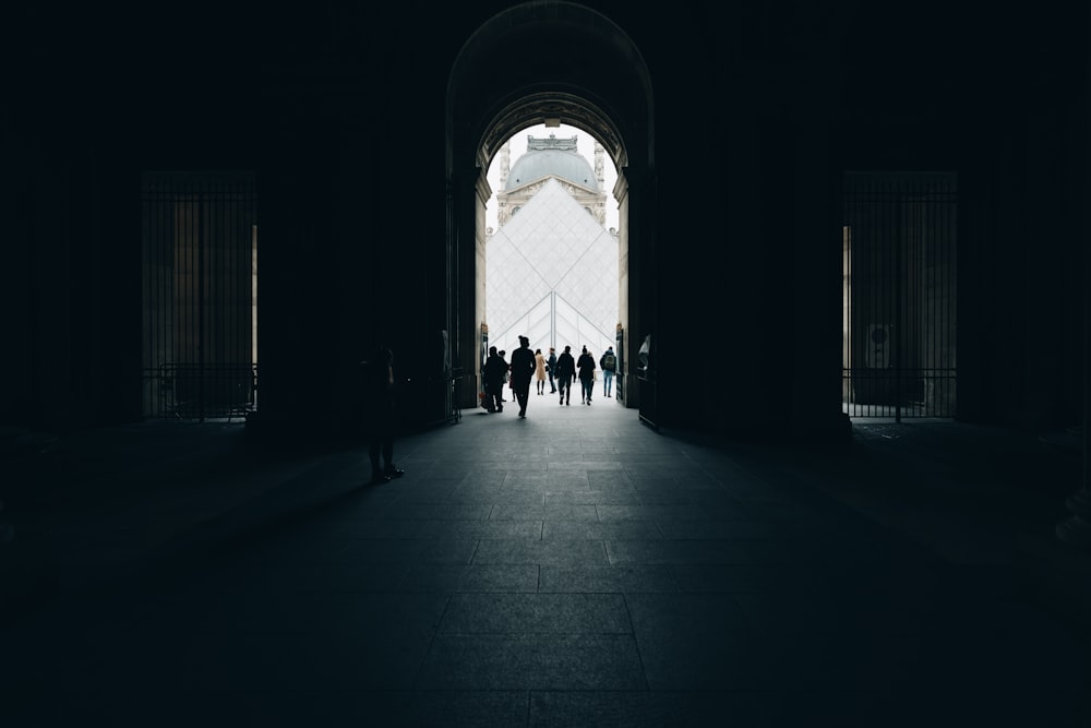 a group of people walking into a dark tunnel