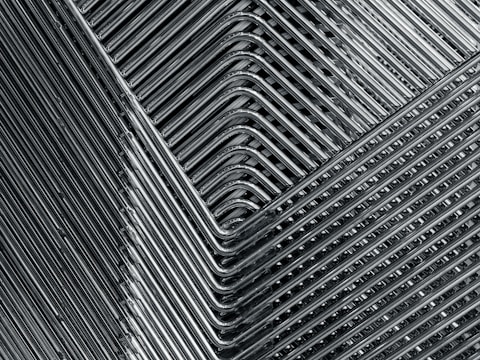 Finished metal furniture pieces arranged in a showroom.