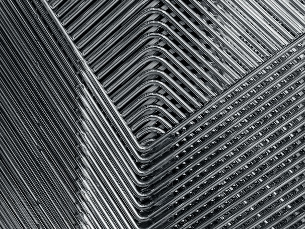 A close-up photo of stylish metal table legs arranged in a workshop setting.