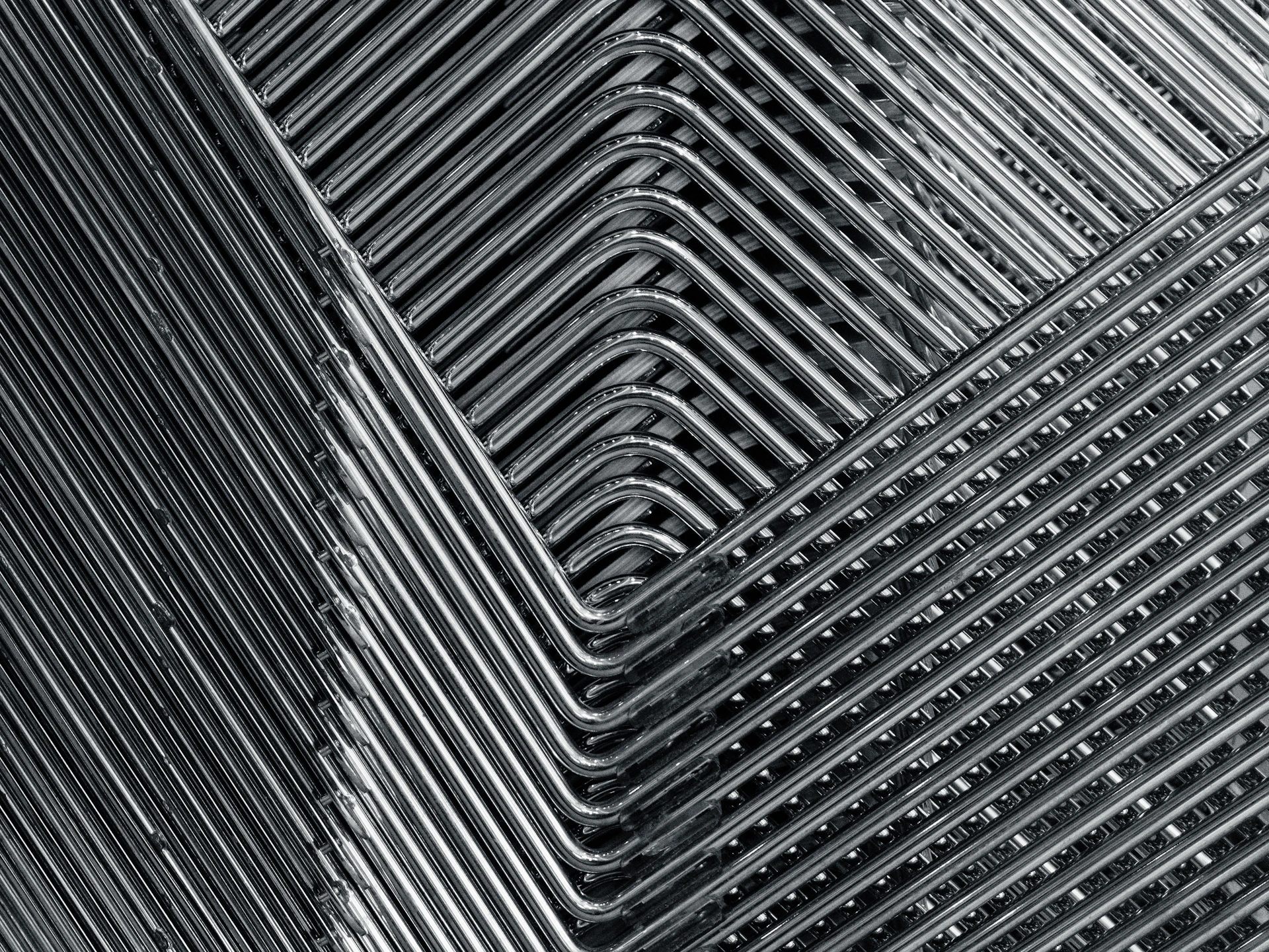 Finished steel furniture pieces lined up in the workshop, highlighting their sleek, modern design and durable finish.