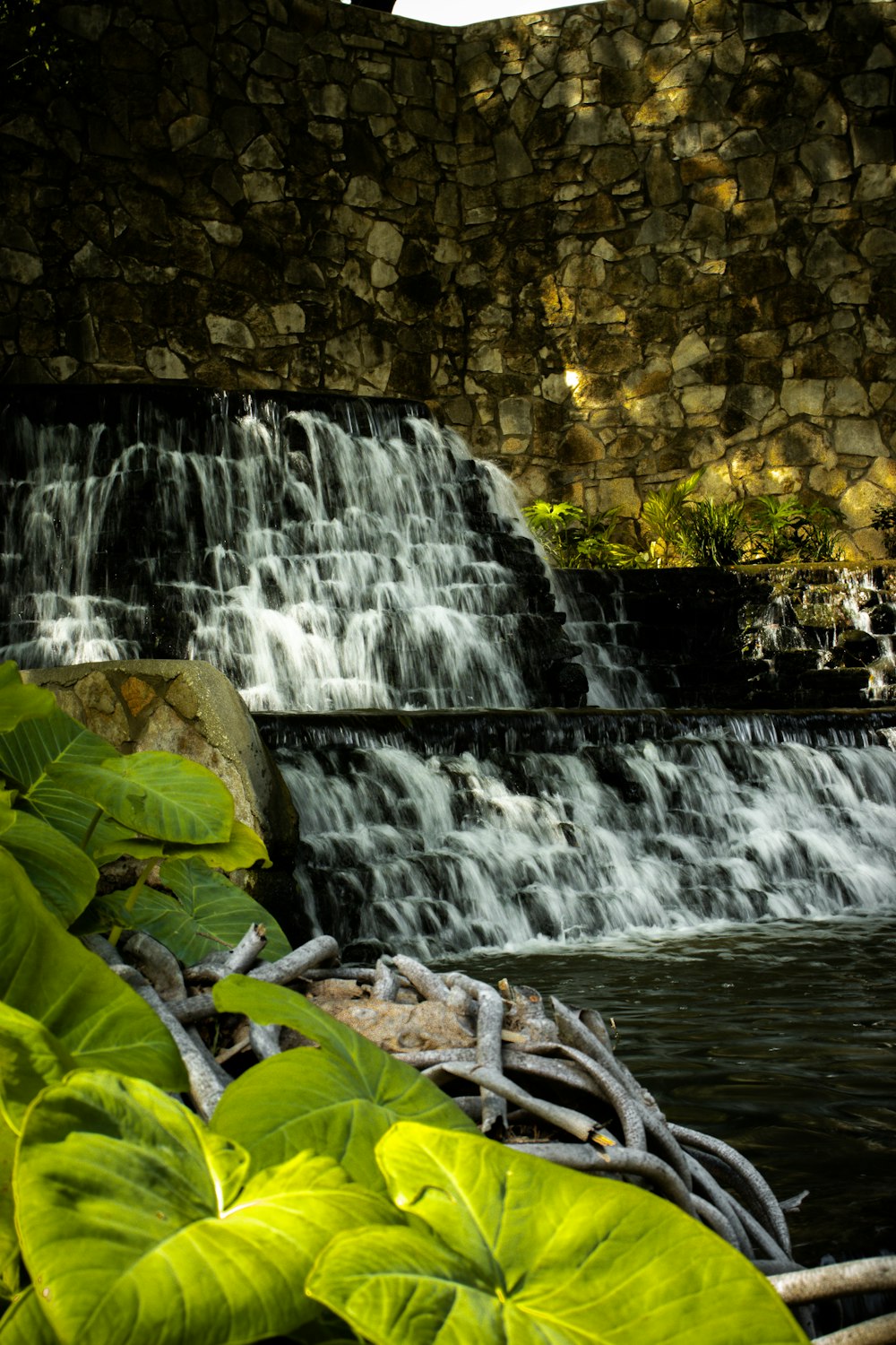 a waterfall with water cascading over it