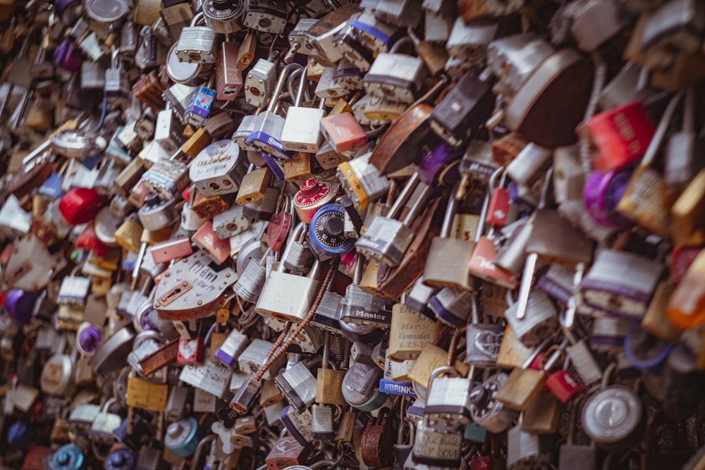 a wall covered in lots of padlocks and locks