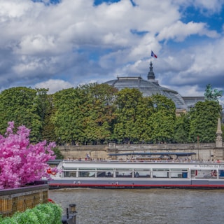 Side view of the Libertas filling half the frame, showing its sturdy design on the river