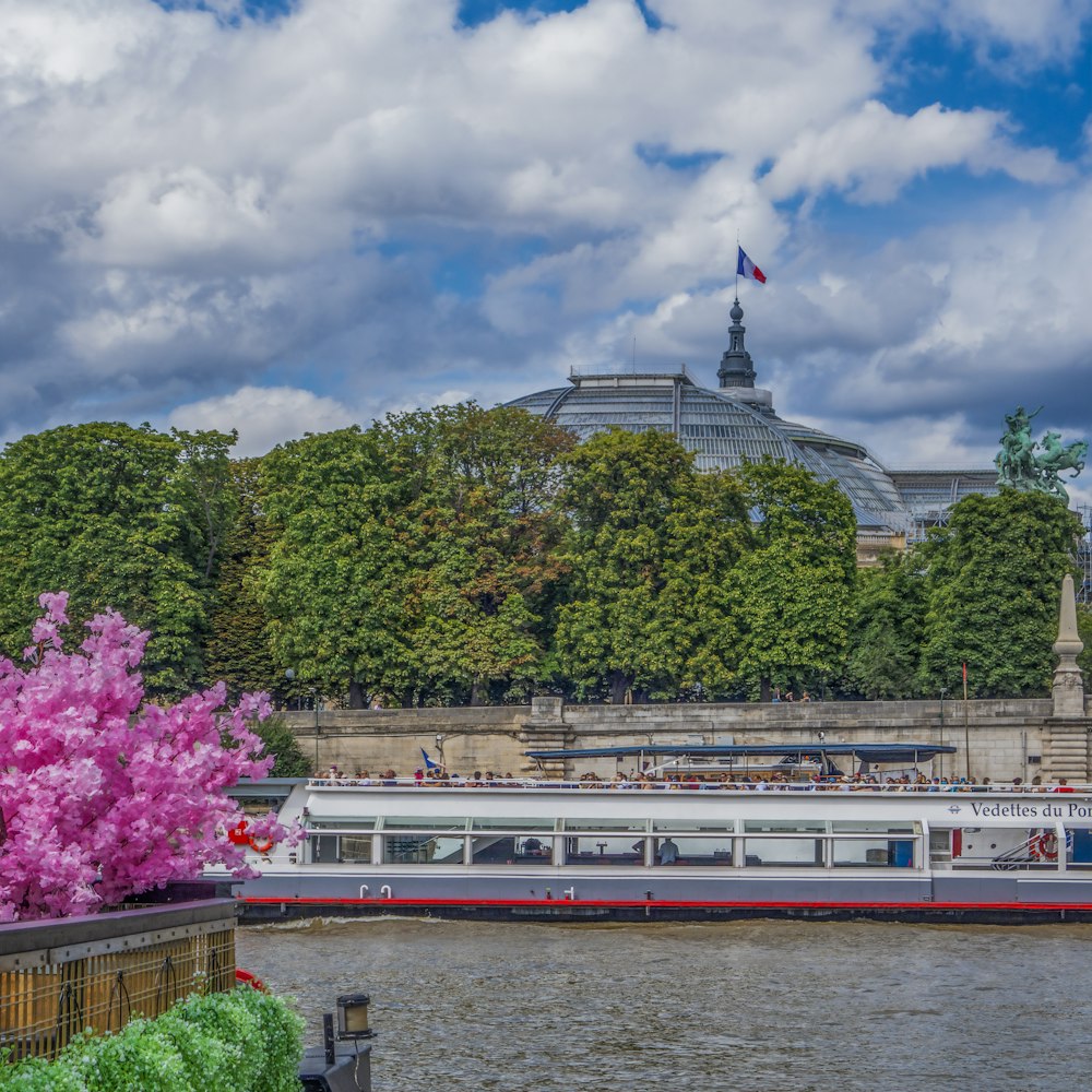 a boat on a river with a building in the background