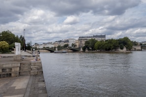 A picturesque Seine River with historic bridges.