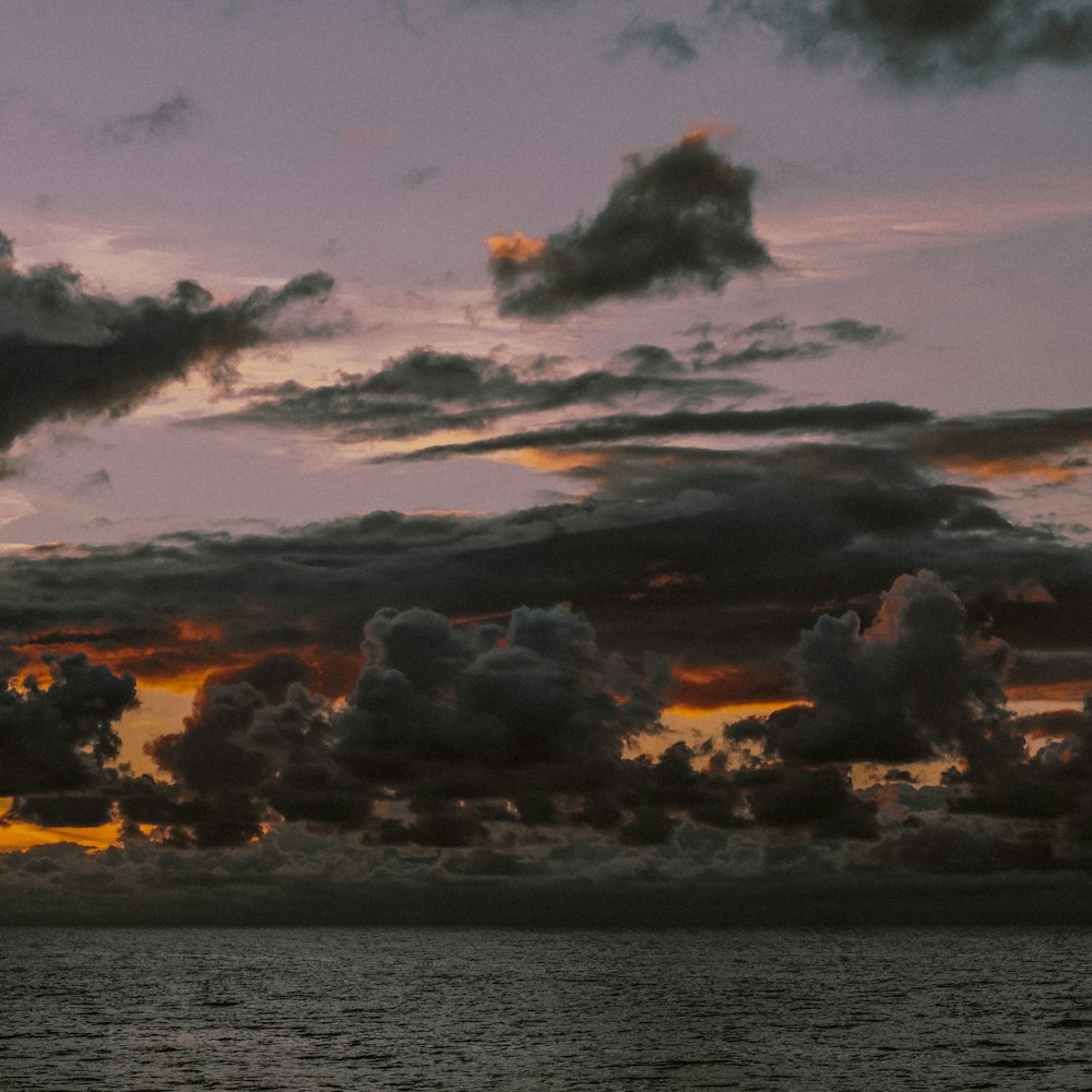 a large body of water under a cloudy sky