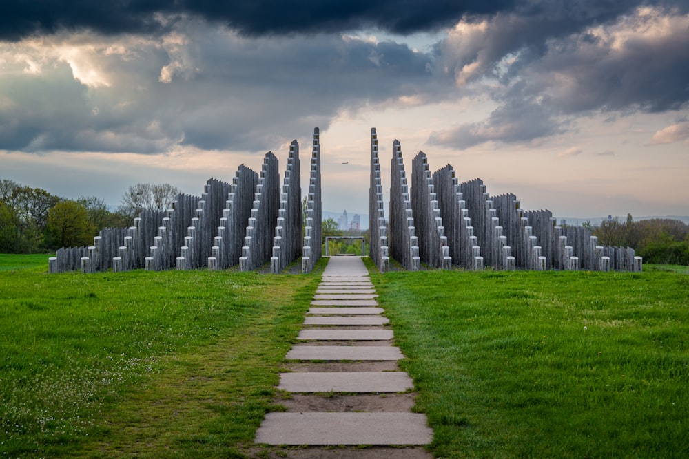 a long stone path in a grassy field