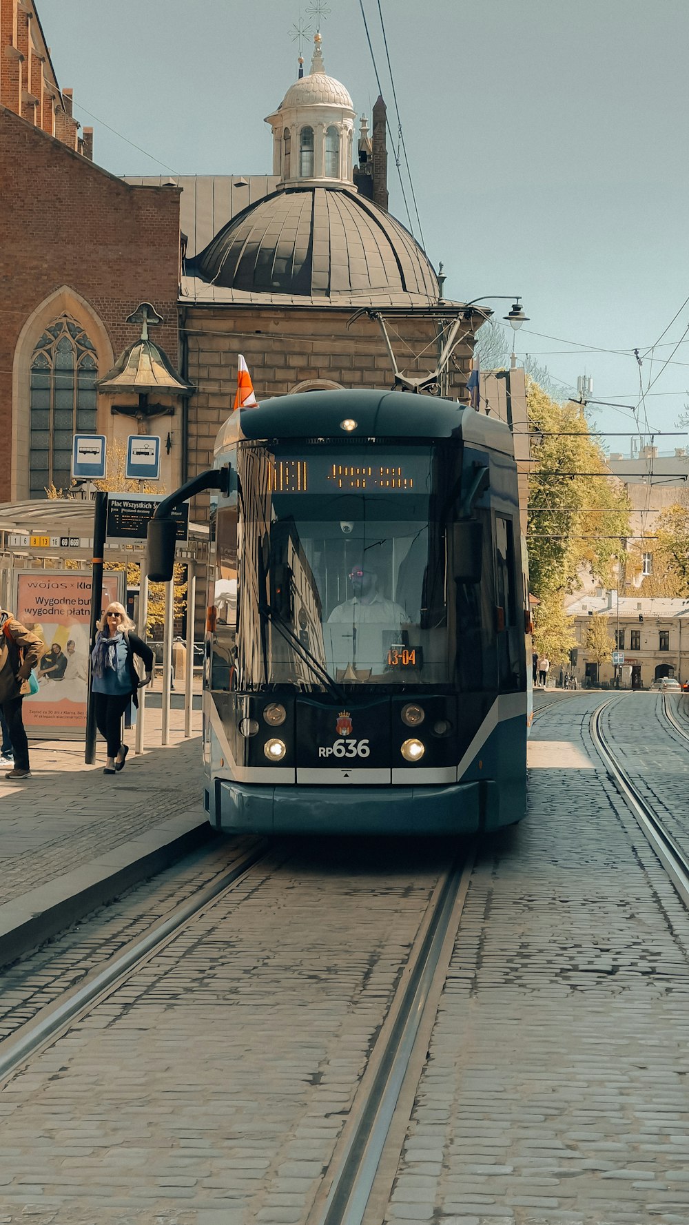 a train on a track in front of a building