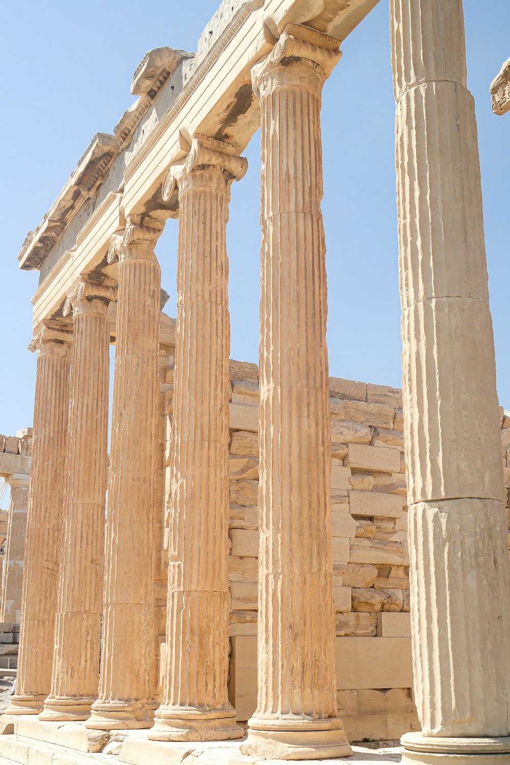 a row of stone pillars in front of a building