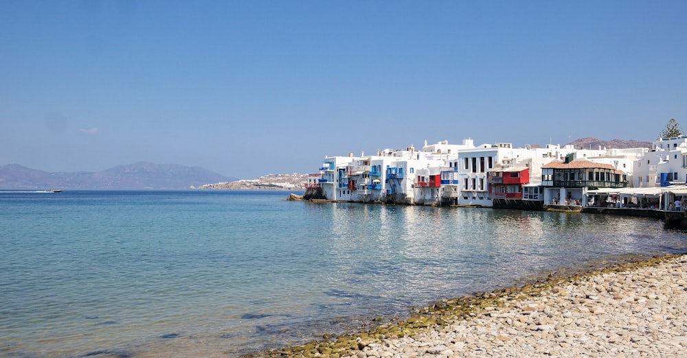 a row of houses sitting next to a body of water