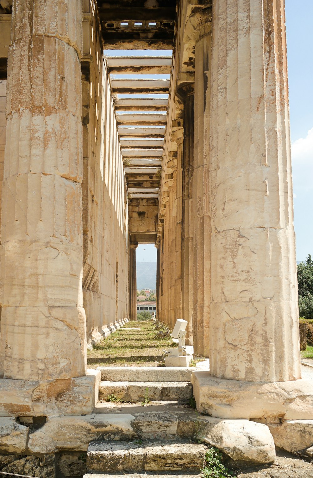 a row of stone pillars with steps leading up to them