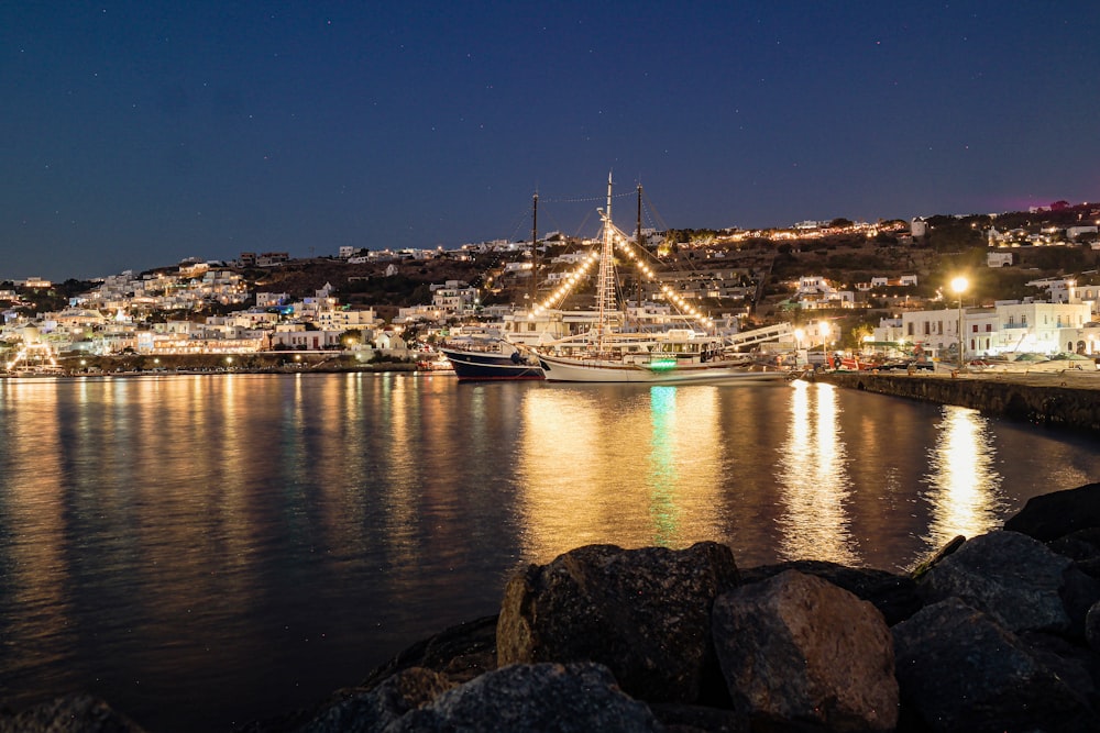 a boat is docked in a harbor at night