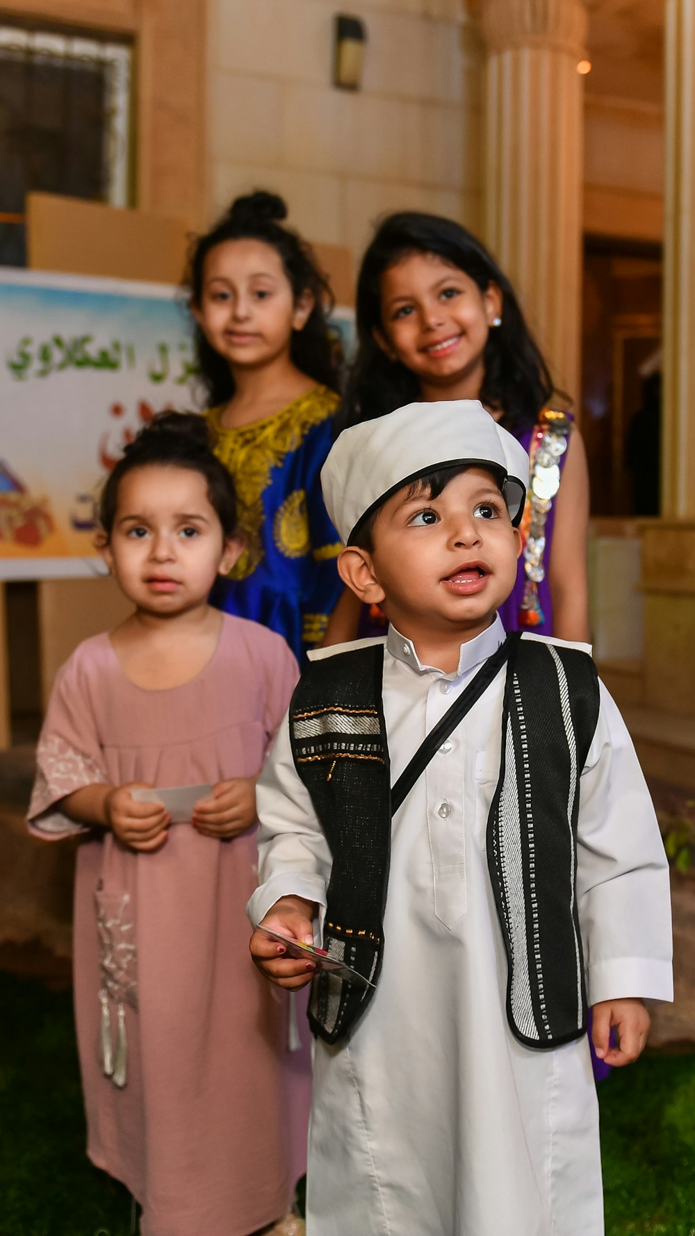 a group of young children standing next to each other