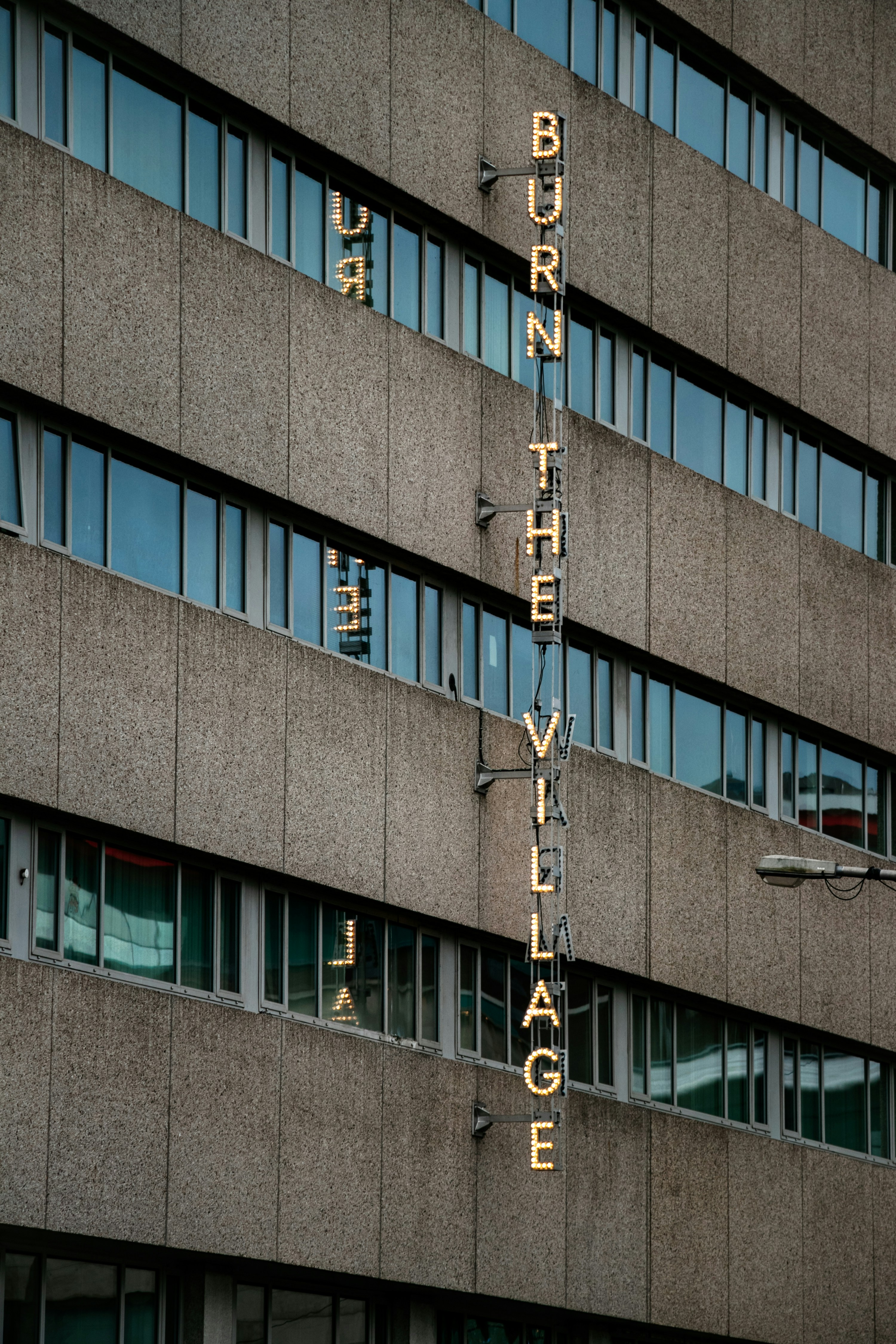 A tall building with a sign on the side of it photo – Free Hotel Image ...