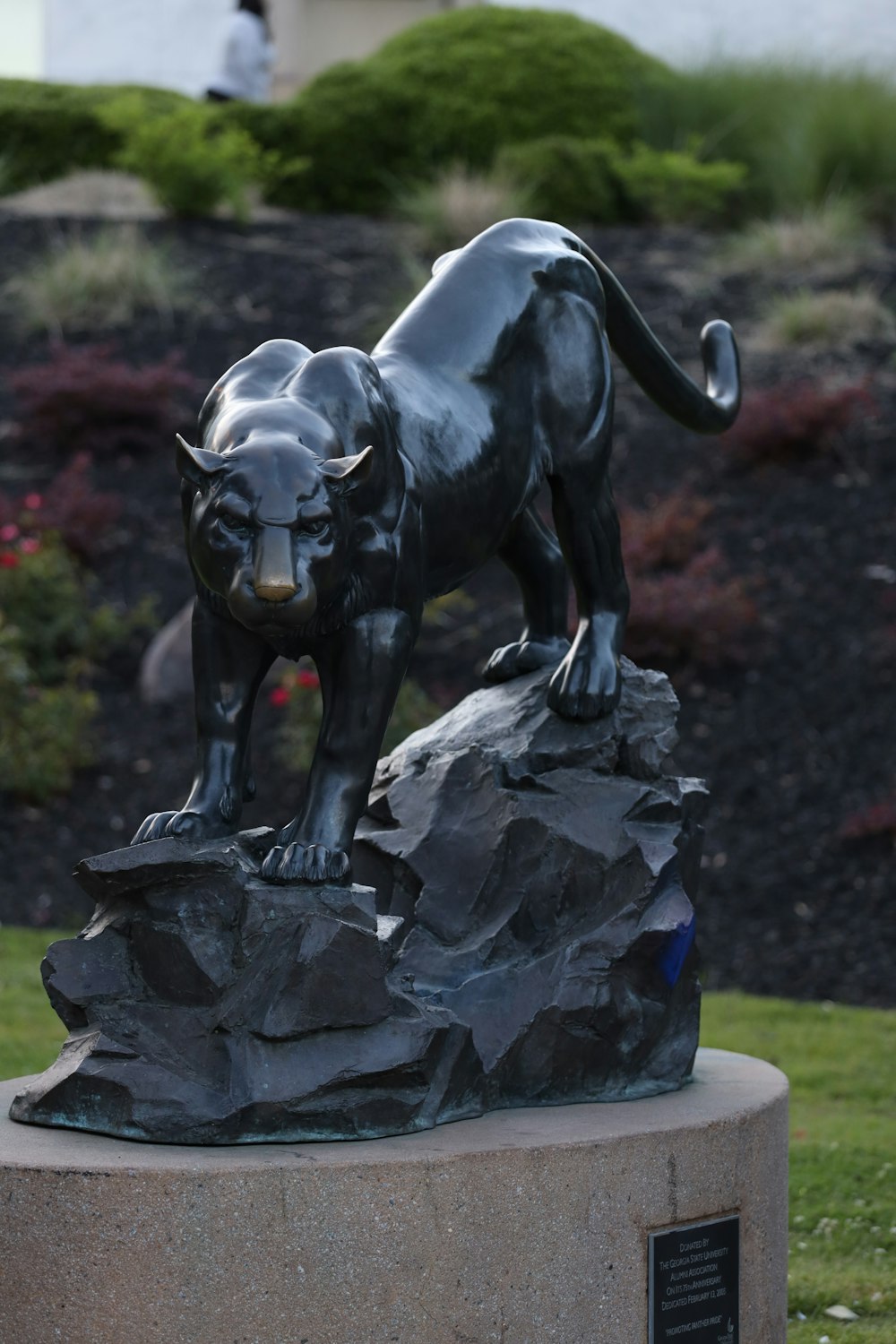 a statue of a black panther on a rock