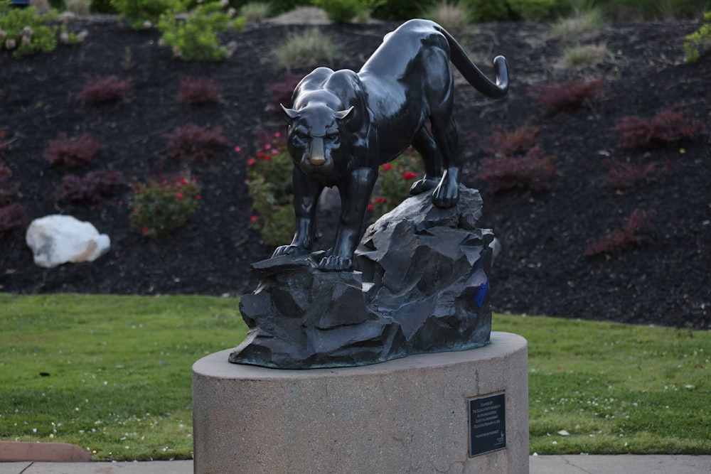 a statue of a dog on top of a rock