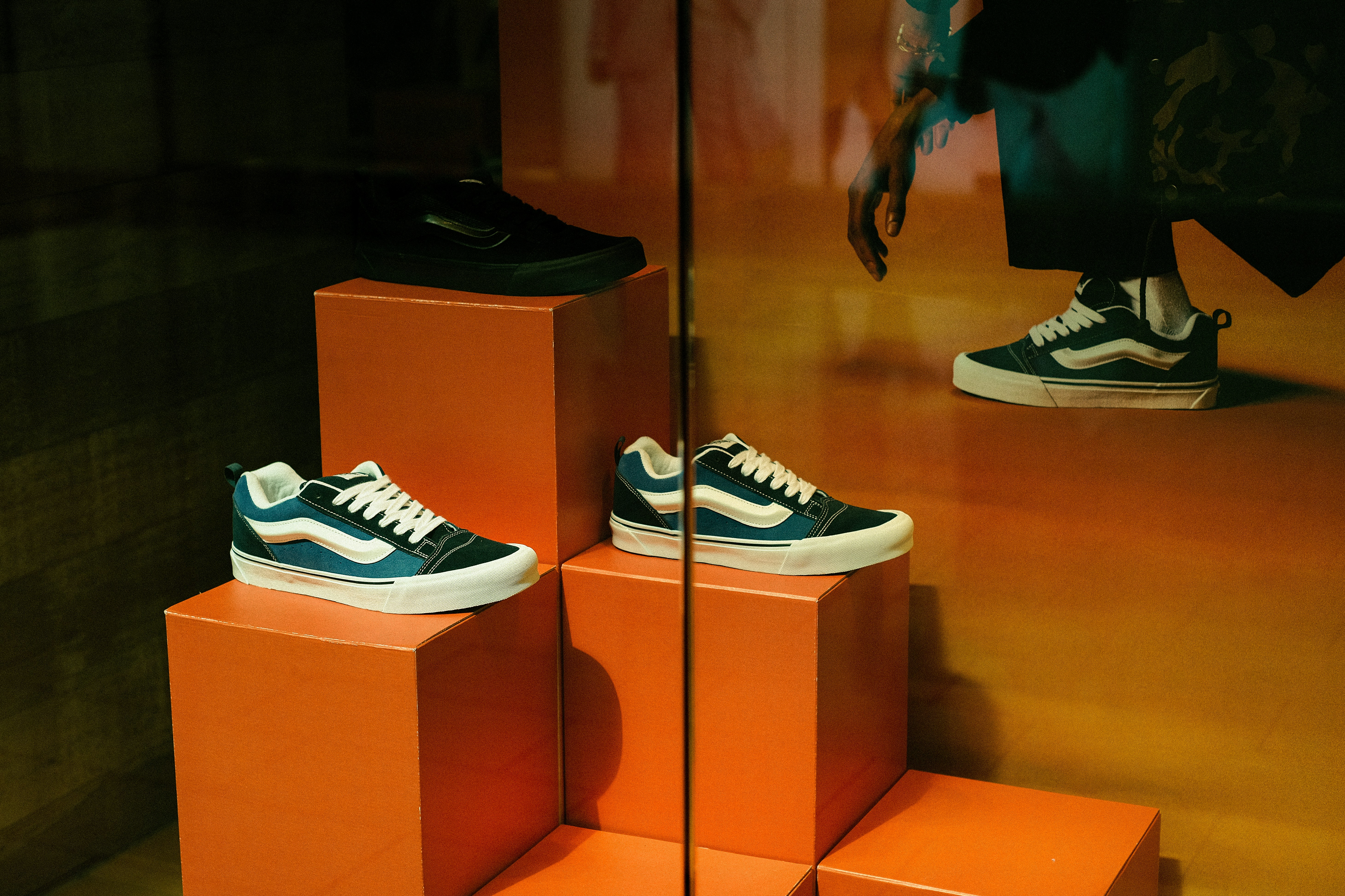 a pair of blue and white sneakers sitting on top of orange blocks