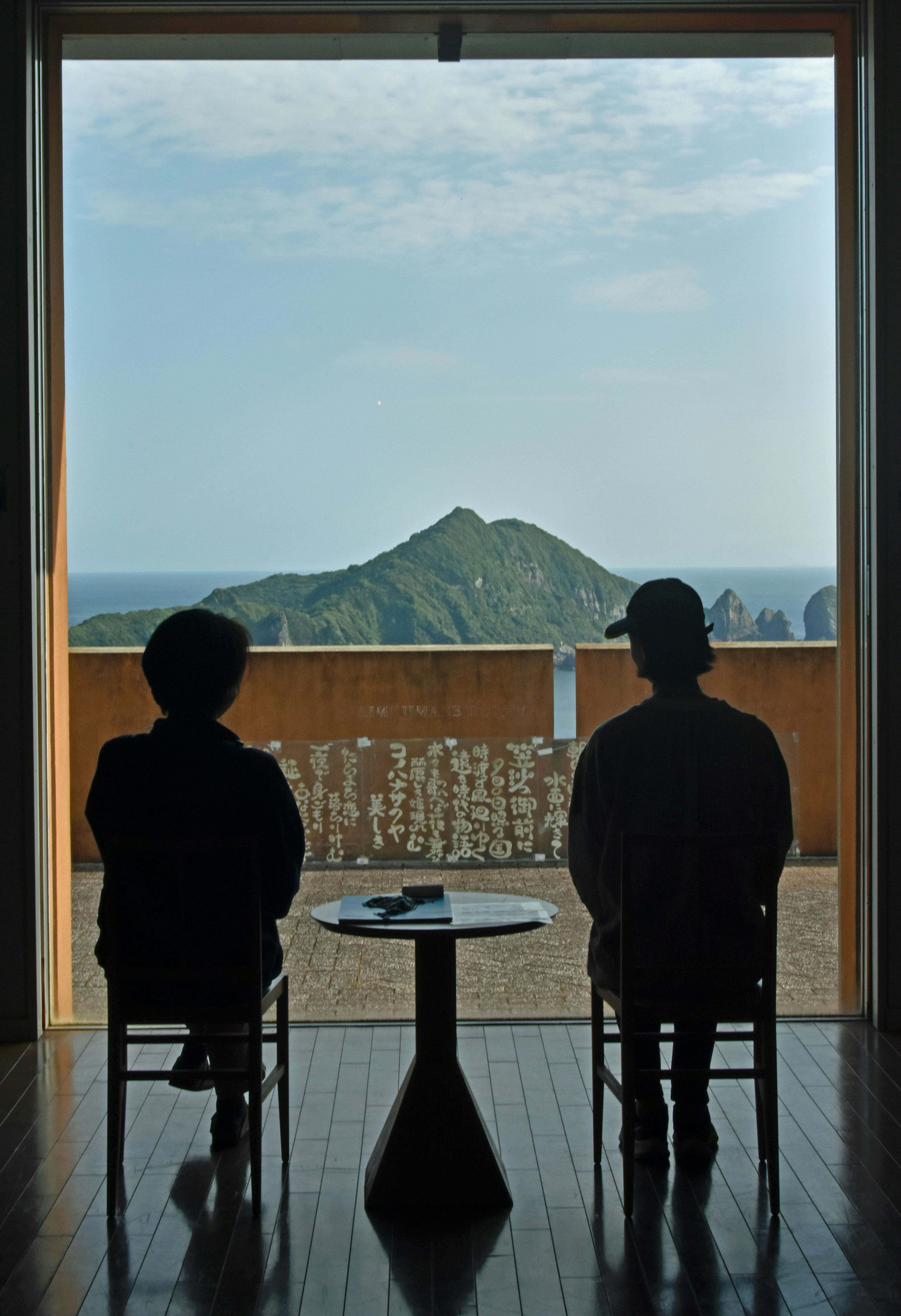 Two people sitting at a table looking out a window photo – Free Kyushu ...