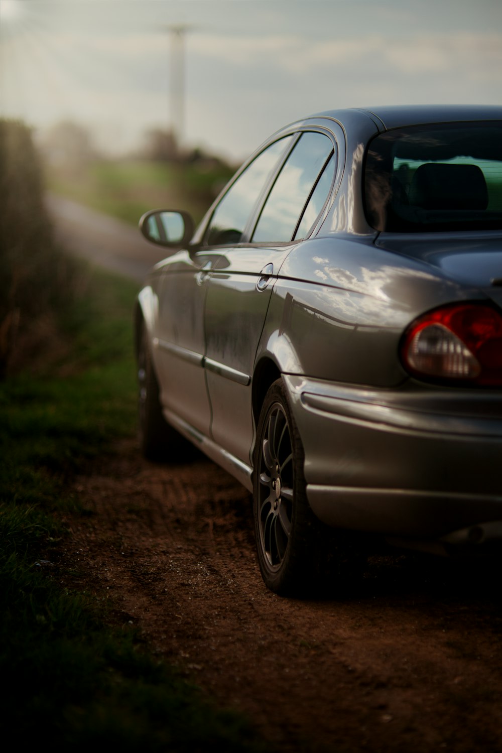 a car parked on the side of a dirt road